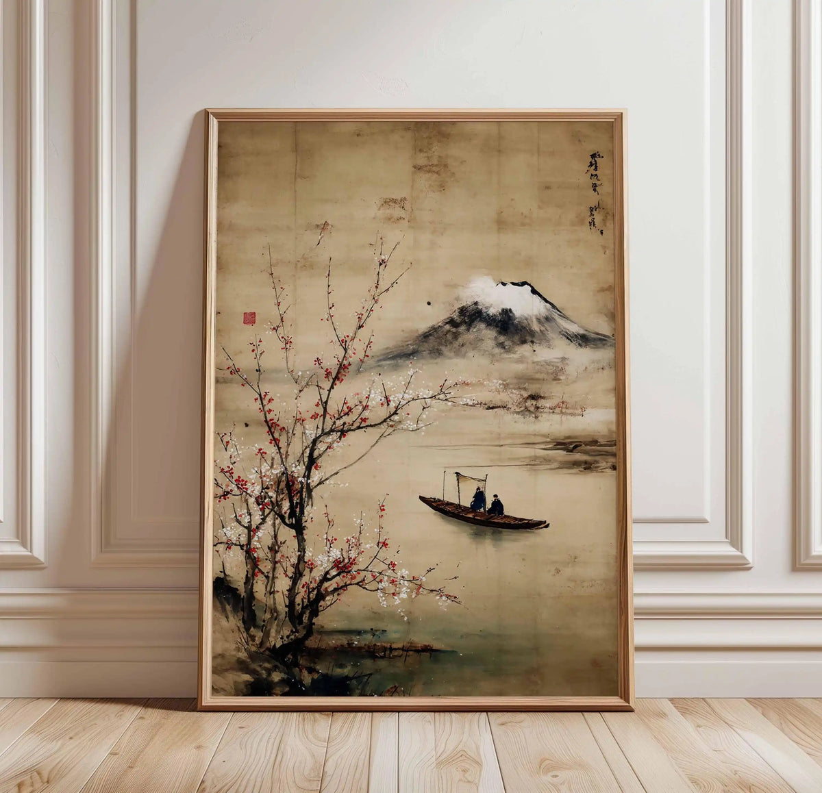 Framed traditional Japanese landscape painting with a boat and cherry blossoms on a wall.