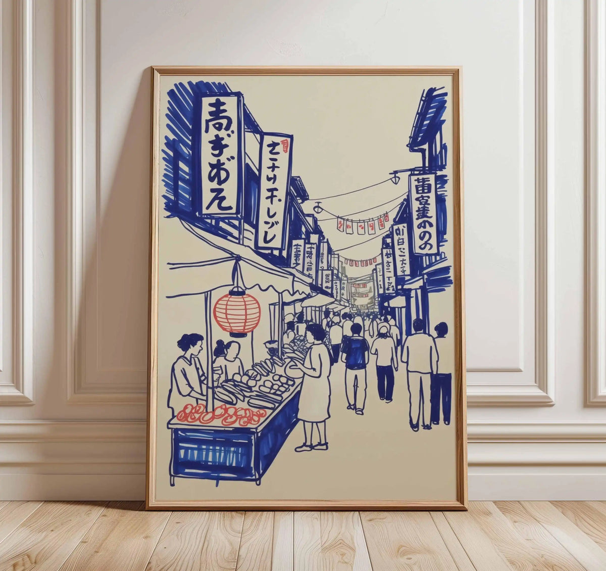 Framed artwork of a Japanese street scene with people and stalls on a beige wall.