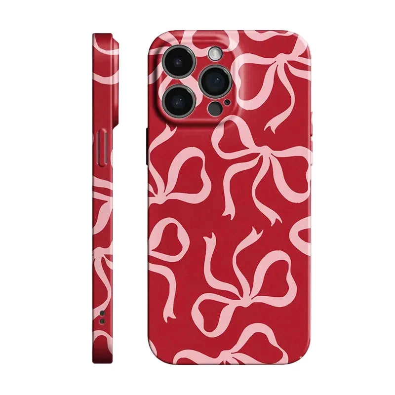 Red phone case with a light pink abstract ribbon or bow pattern, shown from both the back and side views on a white background.
