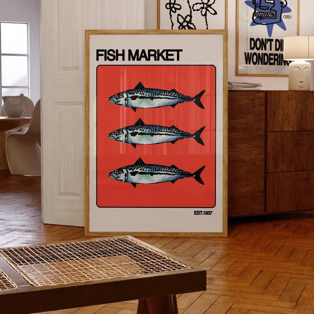 Framed poster with fish design on a wall in a room with wooden floor and furniture.