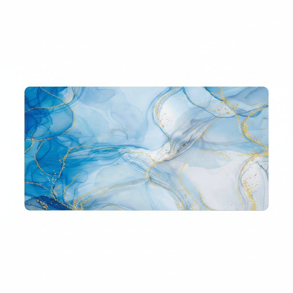 A rectangular desk mat with rounded corners featuring an abstract blue and white fluid marble pattern accented with shimmering gold veins, shown against a plain white background.