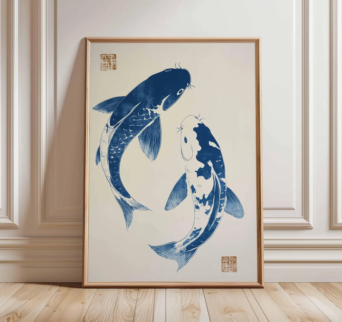 Framed artwork of two blue koi fish on a beige background