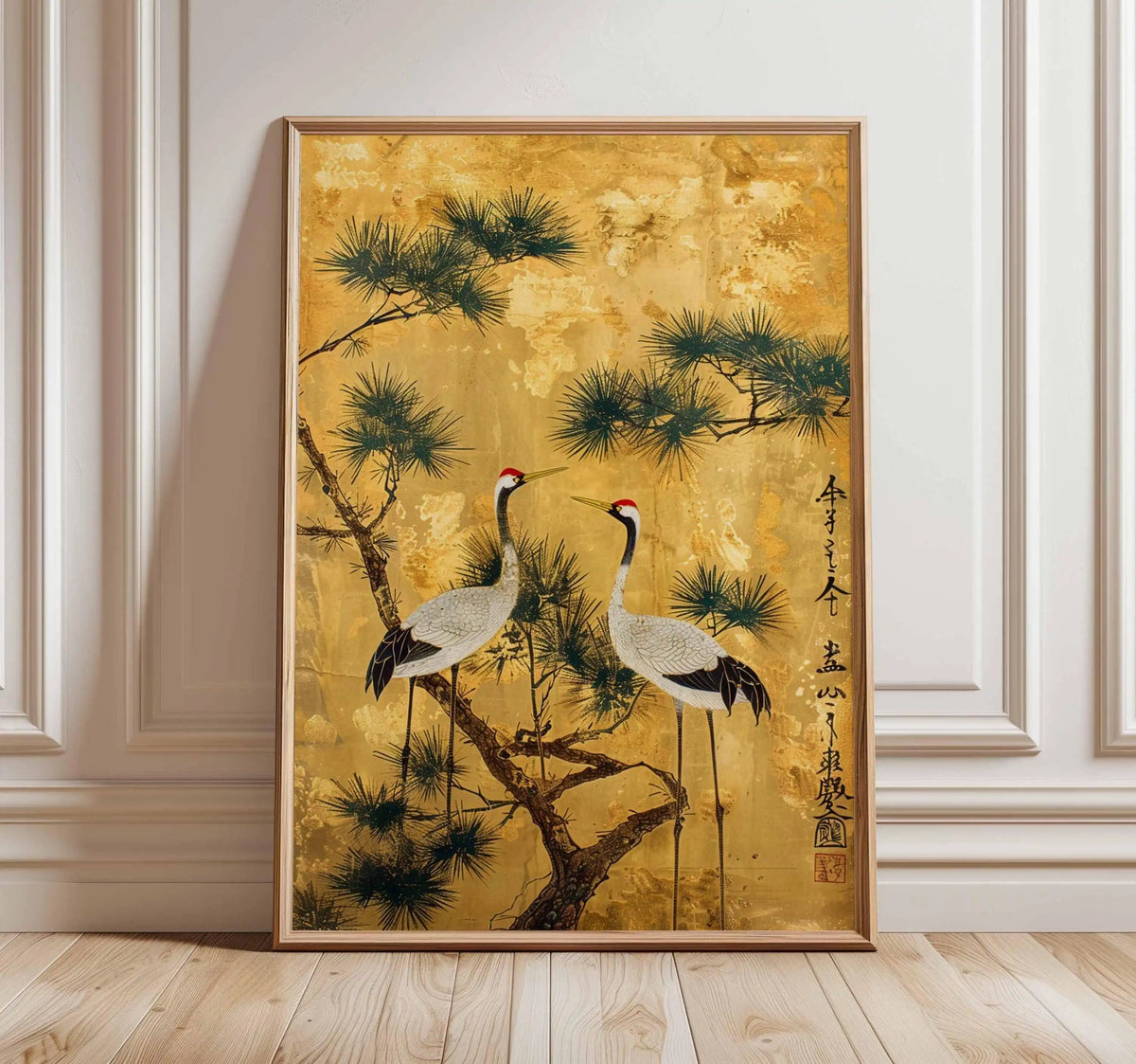 Framed artwork of cranes on a gold background with a wooden frame.