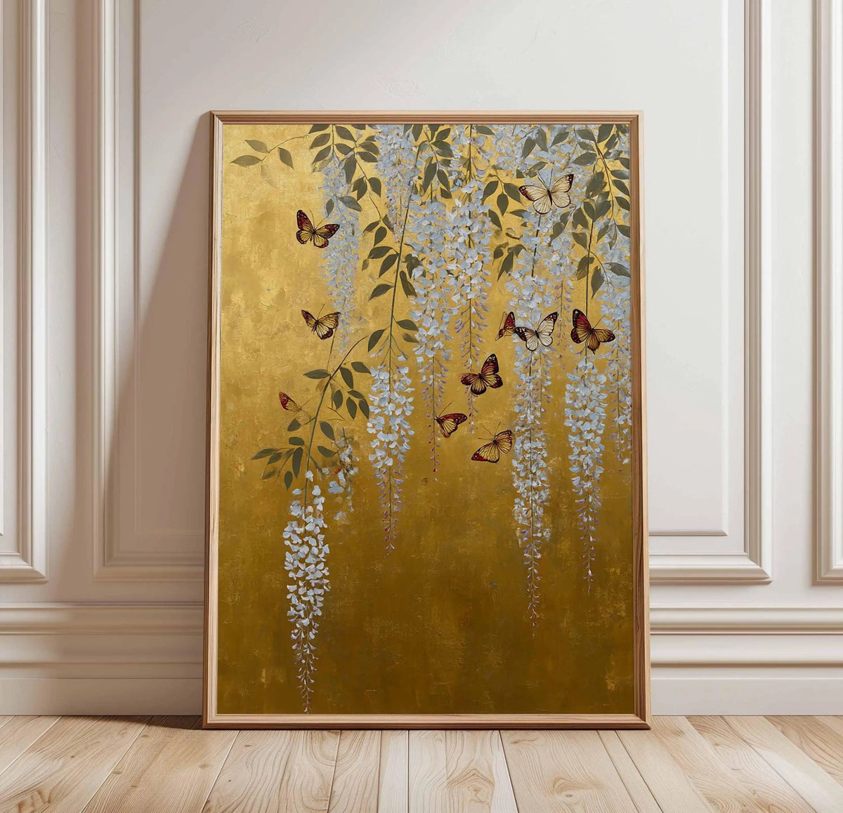 Decorative painting of butterflies and flowers on a gold background in a frame, hanging on a wall.