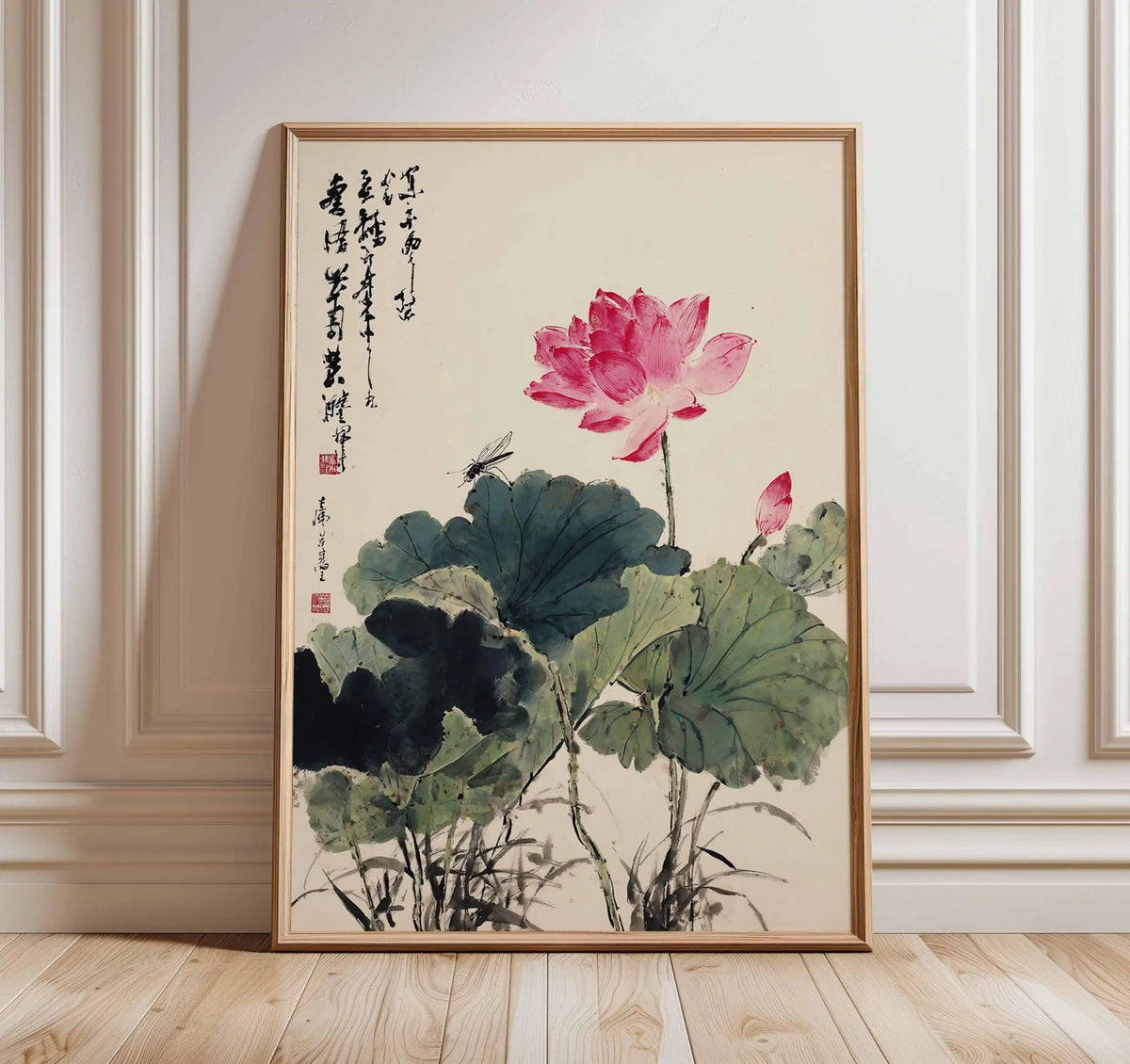 Framed artwork of a pink lotus flower on a beige wall.