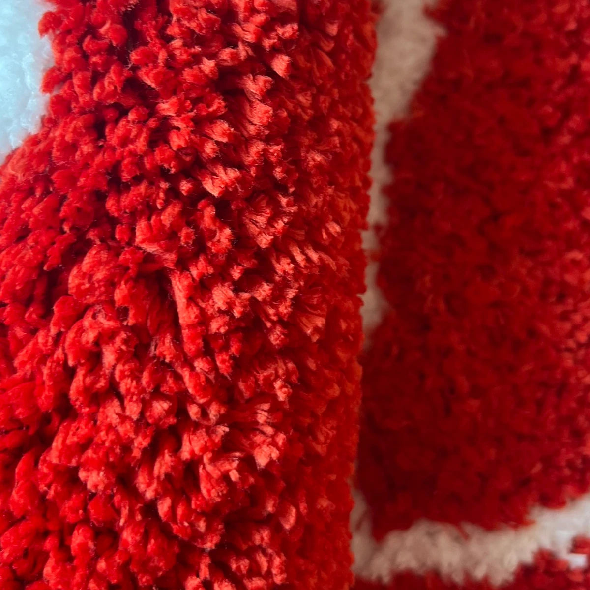 Close-up of the red pile and white pip details on the dice rug