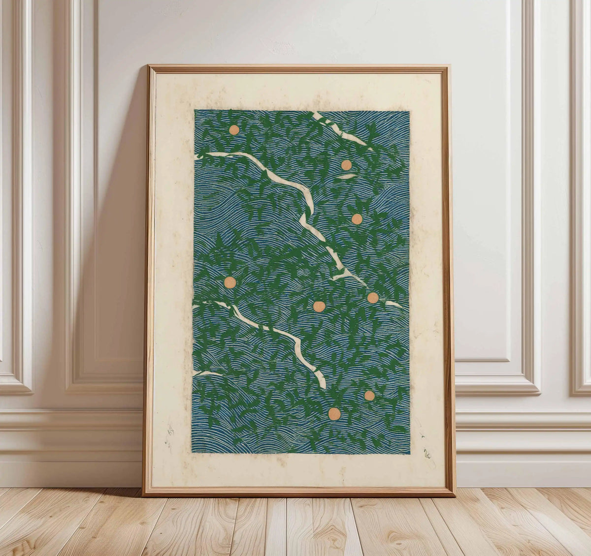 Framed artwork with a green and blue pattern on a white wall.