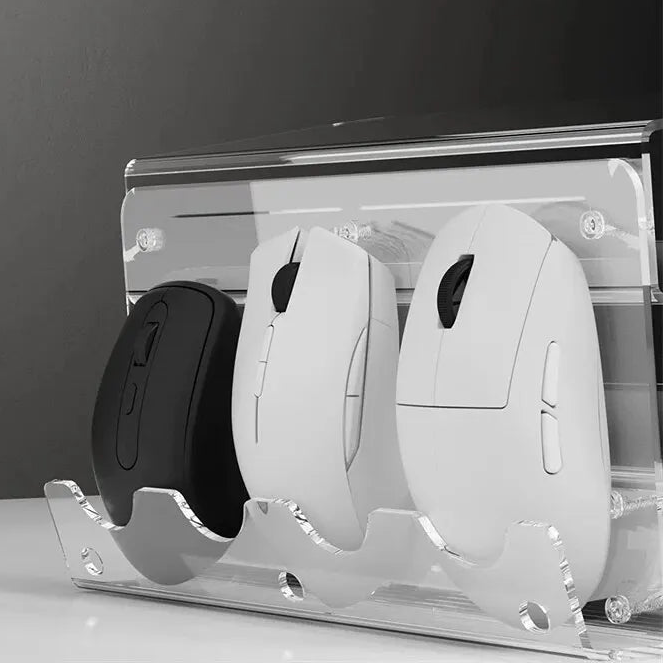 Three computer mice on a clear stand against a dark background
