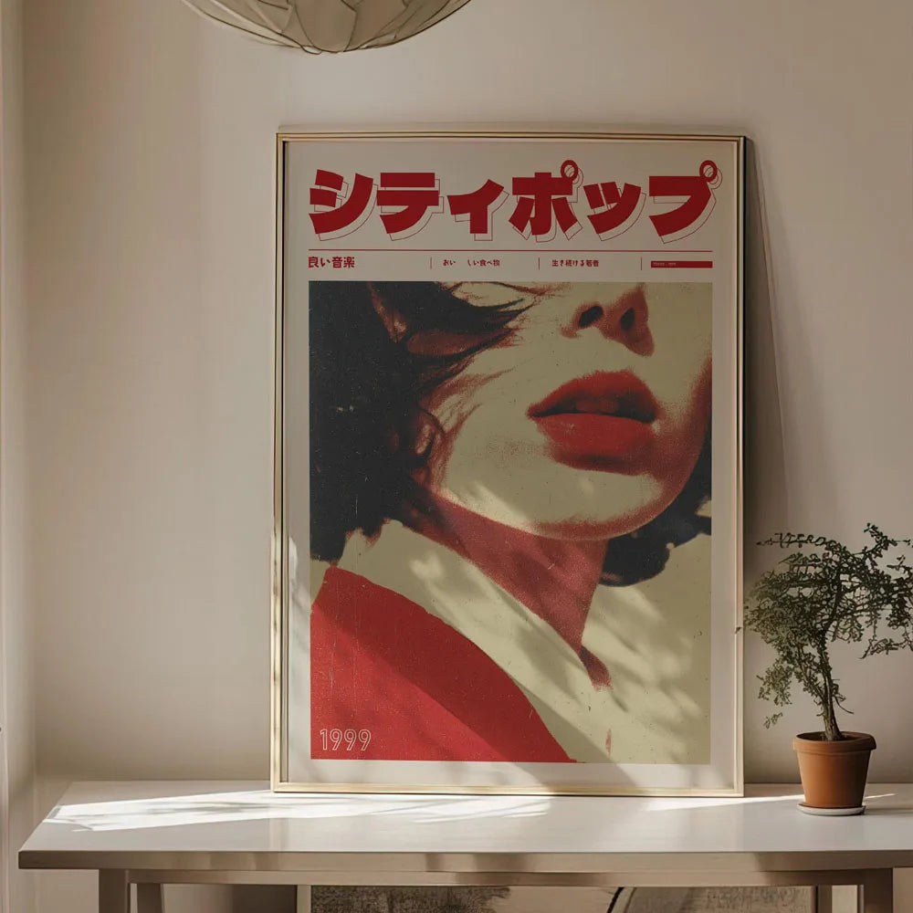 Framed poster with a stylized face and Japanese text on a wall.
