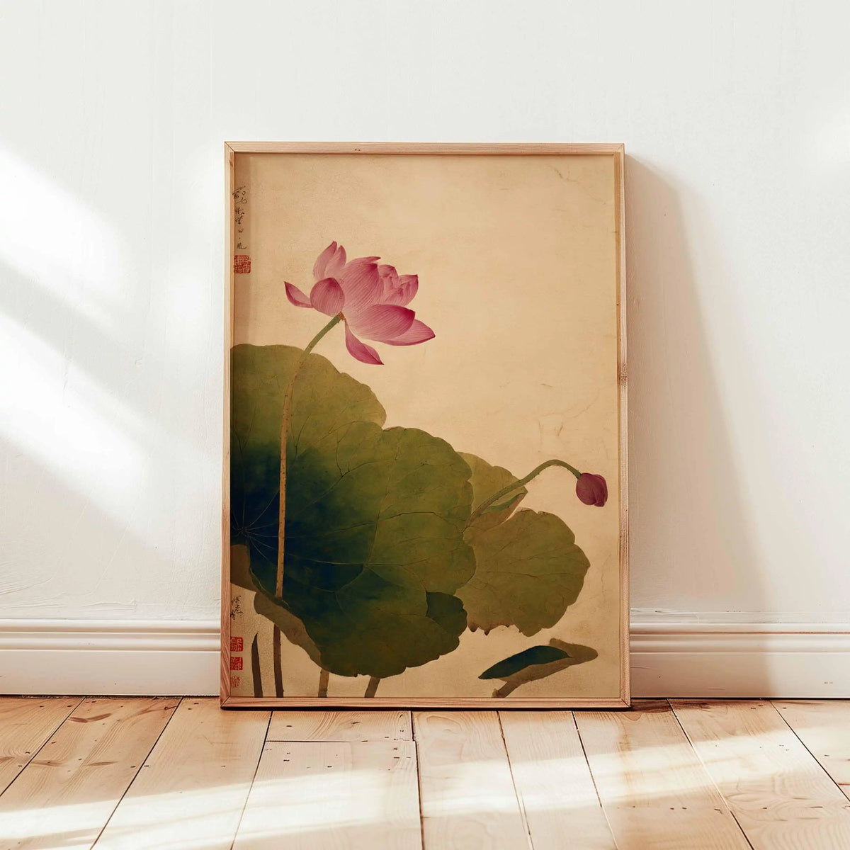 Framed artwork of a pink lotus flower on a beige wall.