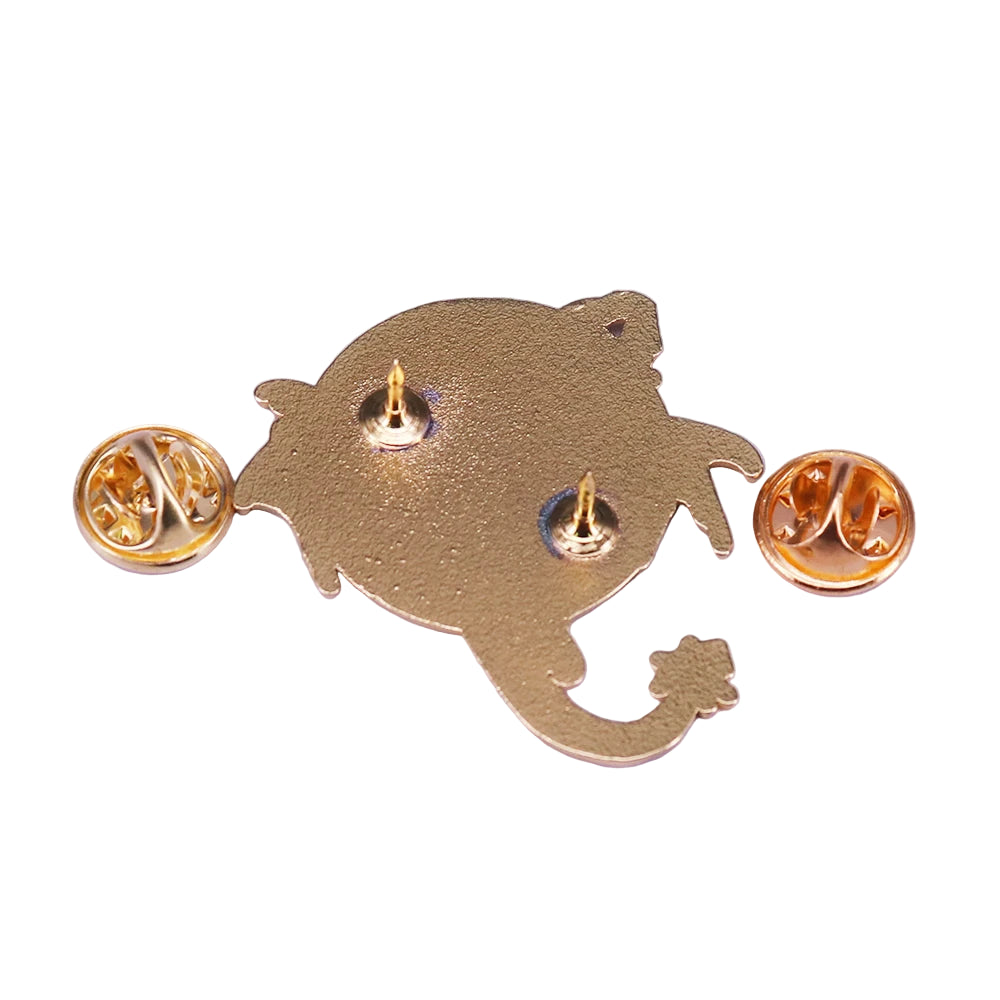 Back of a gold dragon-shaped brooch on a white background