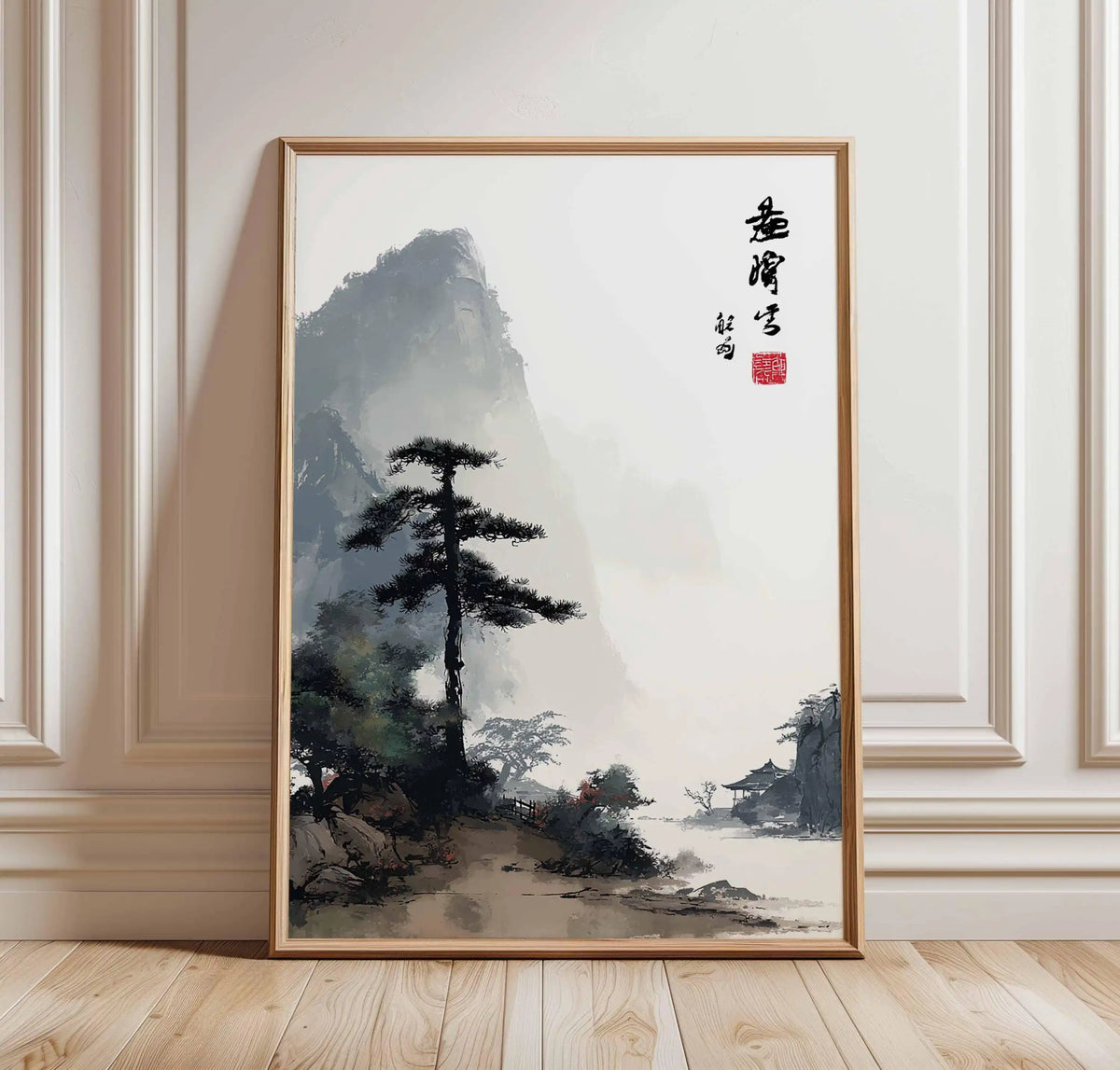 Framed Chinese landscape painting with mountains and trees on a wall.