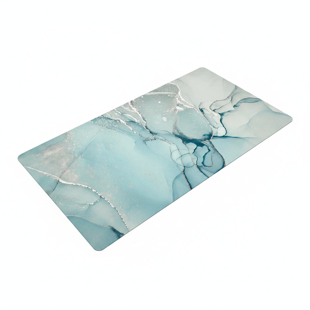 A rectangular mat with rounded corners featuring an abstract liquid marble design in shades of light blue, white, and gray, shown on a plain white background.