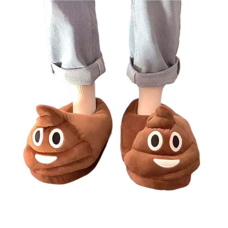 Brown poop emoji slippers worn by a person on a gray floor.