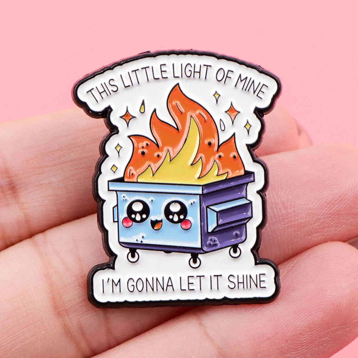 This Little Light of Mine enamel pin held in hand