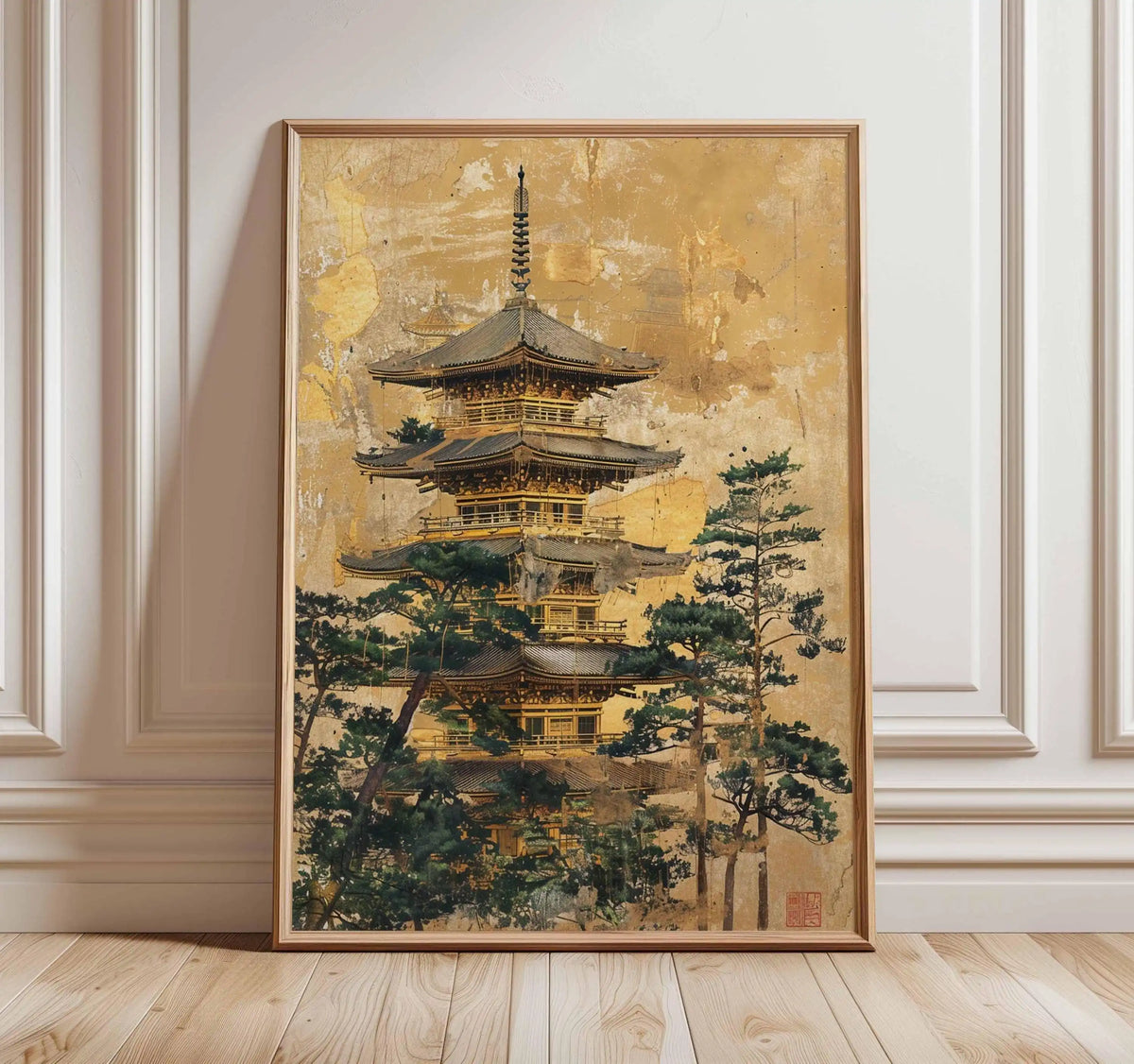 Framed artwork of a pagoda with trees on a gold background, displayed on a wall.