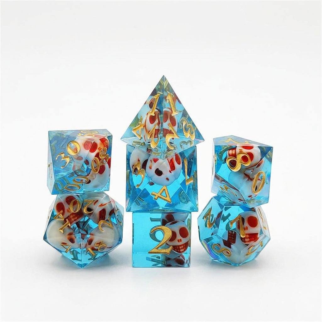 Seven translucent blue resin polyhedral dice with embedded skull details and numbered faces