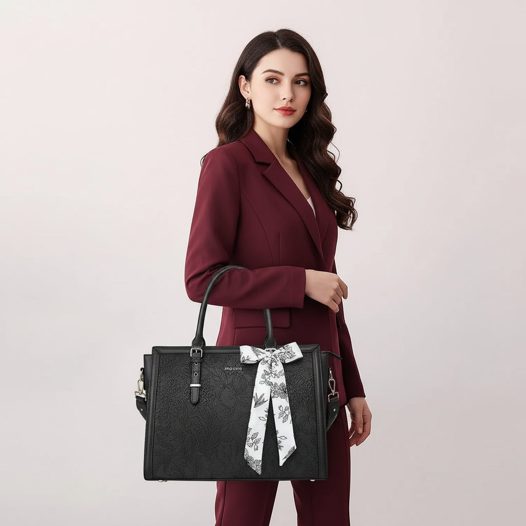 Woman carrying MOSISO floral laptop tote bag in black