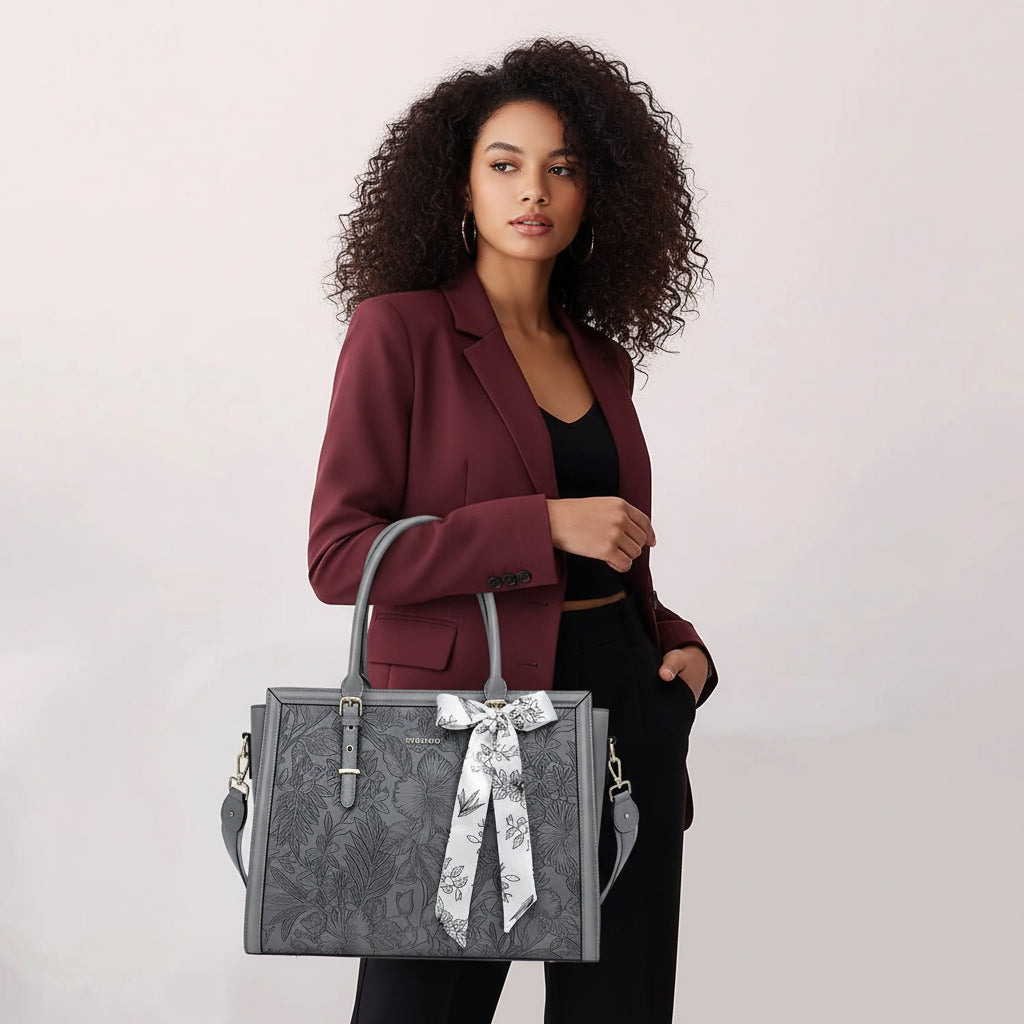 Woman carrying MOSISO floral laptop tote bag in grey