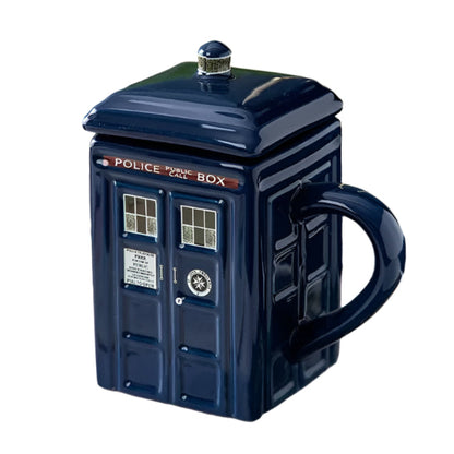 Blue TARDIS mug with a lid on a surface with a blurred background