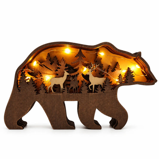 A bear-shaped wooden decorative light with laser-cut deer and forest silhouettes, illuminated from within by warm yellow fairy lights 
