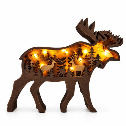 Wooden moose-shaped decorative light with cut-out designs on a gray background