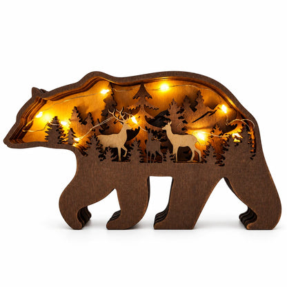 Wooden bear-shaped lamp with cut-out designs of trees and deer on a gray background
