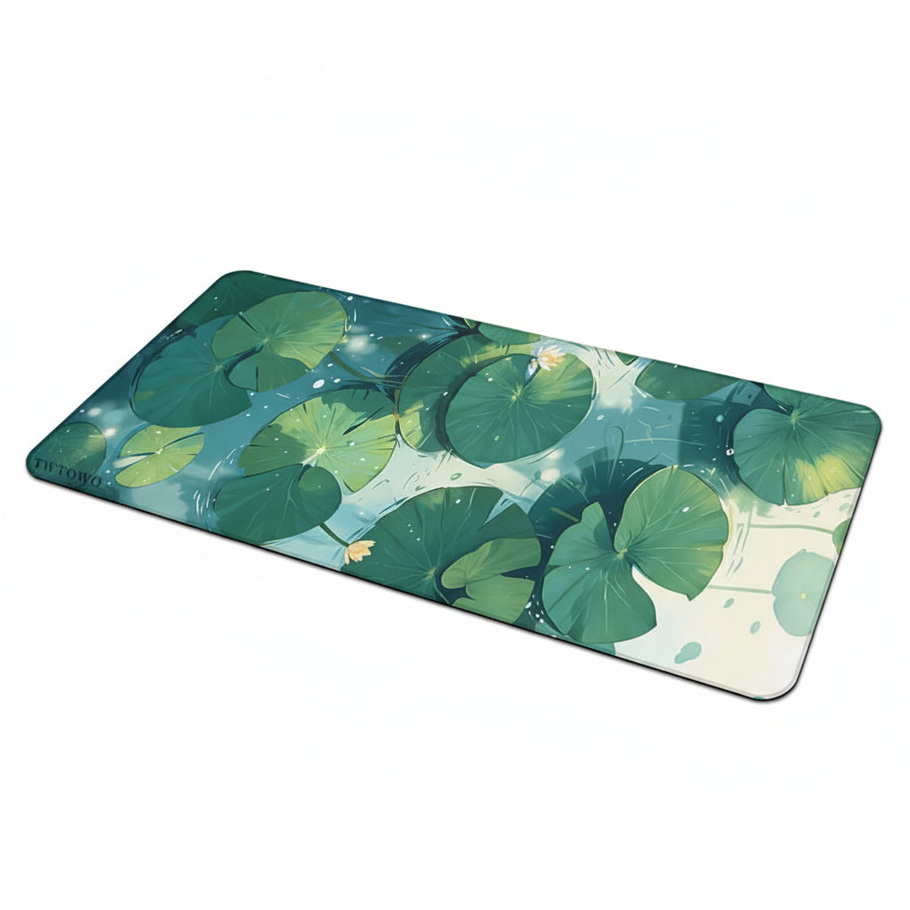 A large desk mat featuring a realistic design of green lily pads and water with a small yellow lotus flower.