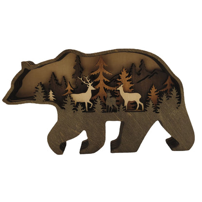 Wooden bear-shaped cutout with laser-cut trees and deer on a white background